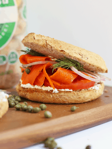 Bagel and Carrot Lox Sandwich on a wooden platter