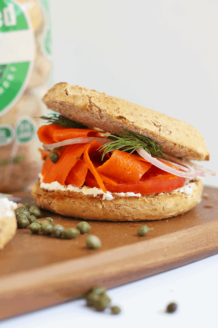 Bagel and Carrot Lox Sandwich on a wooden platter