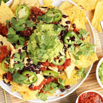 Finished plate of vegan nachos with fresh guacamole