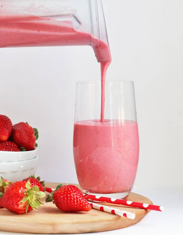 Strawberry Cheesecake Smoothie poured into a glass from the blender