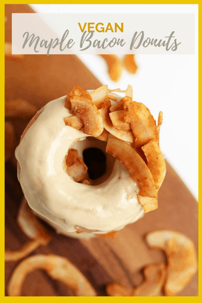 Vegan Maple Bacon Doughnuts! These amazing doughnuts are lightly spiced and baked to perfection. Finished them off with a sweet maple glaze and crispy coconut bacon for a delicious morning pastry.