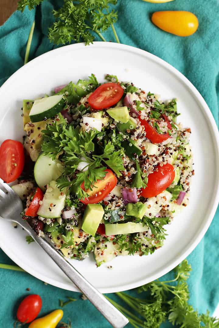 Mediterranean Quinoa Salad on a white plate with a fork