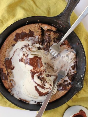 Finished dessert in a skillet with two forks