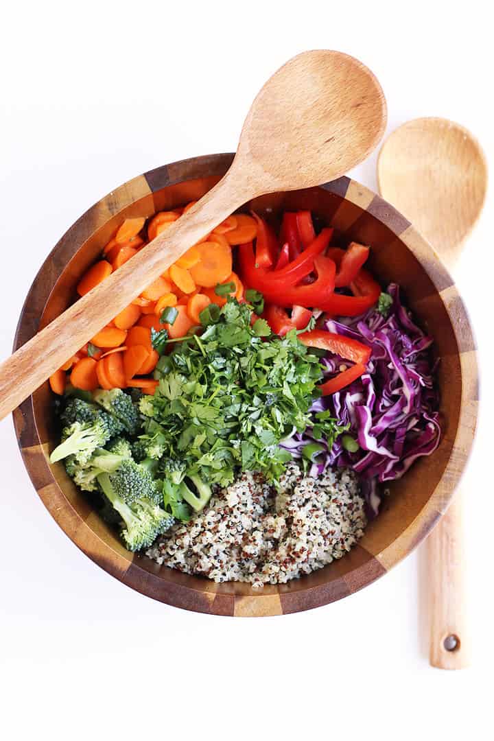 Thai Peanut Salad in a salad bowl with wooden spoons