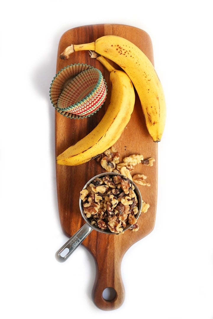 Bananas and walnuts on a wooden cutting board