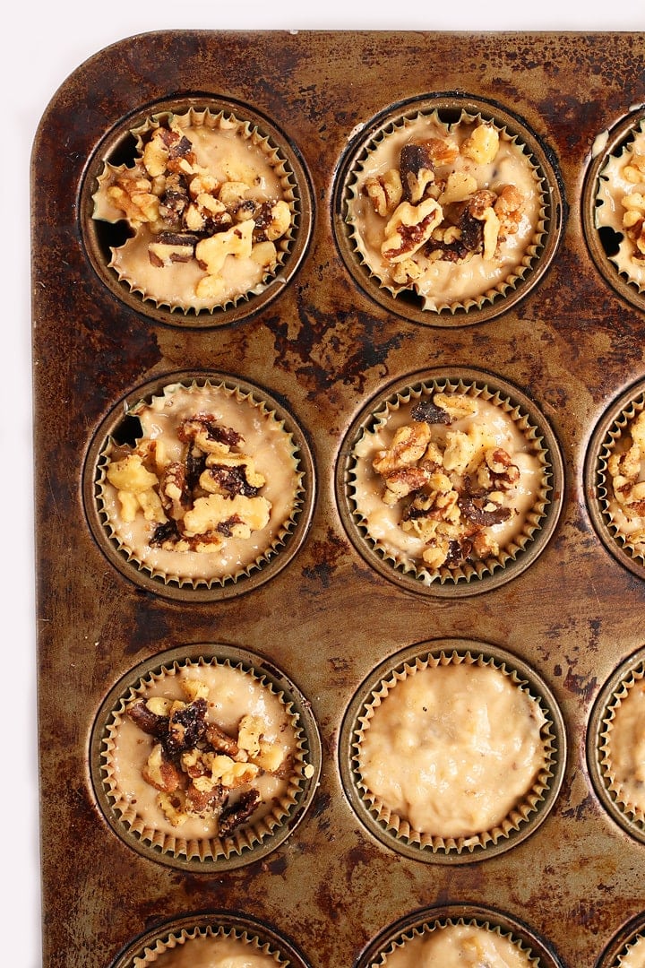 Banana muffin batter in a muffin tin