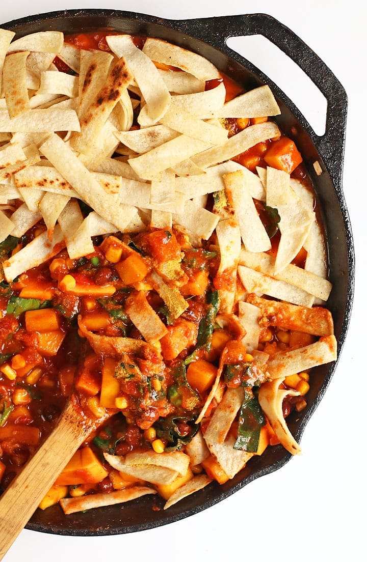 Beans, squash, and corn tortillas in a large cast iron skillet