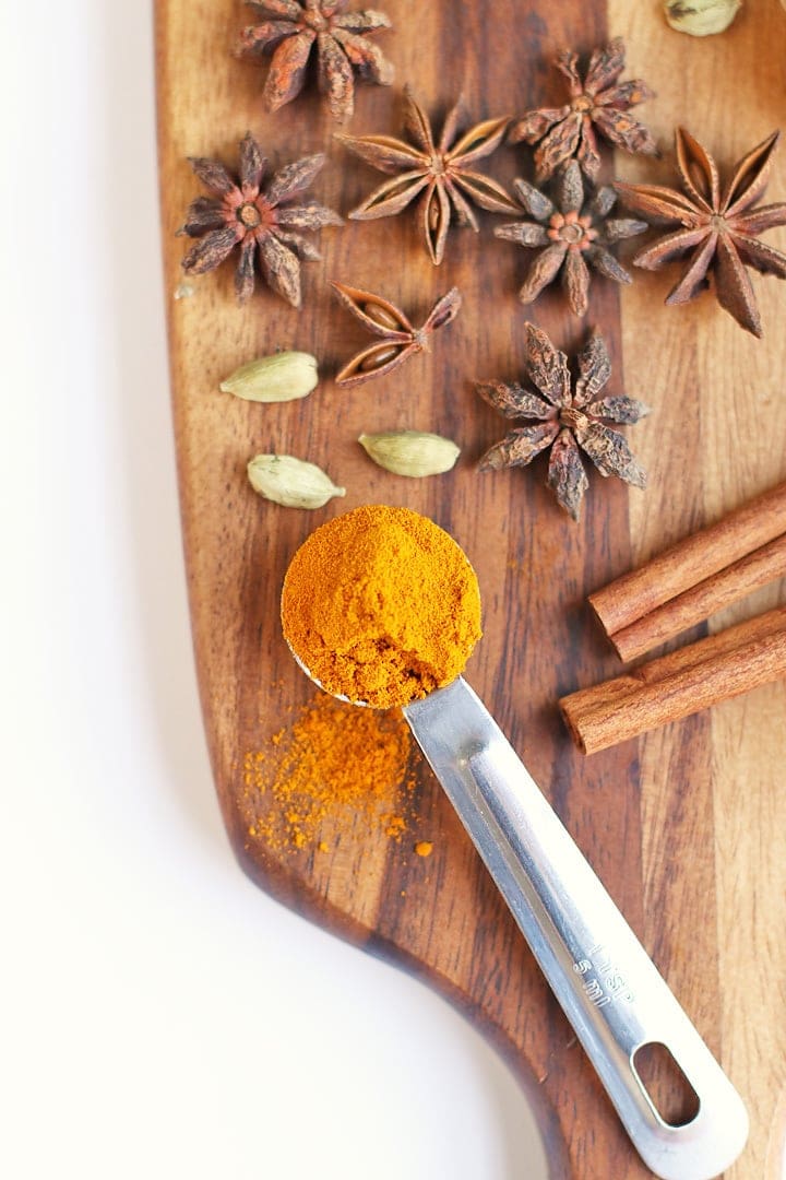 Whole spices and turmeric on a wooden board