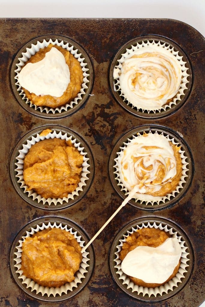 Pumpkin muffin batter in a muffin tin