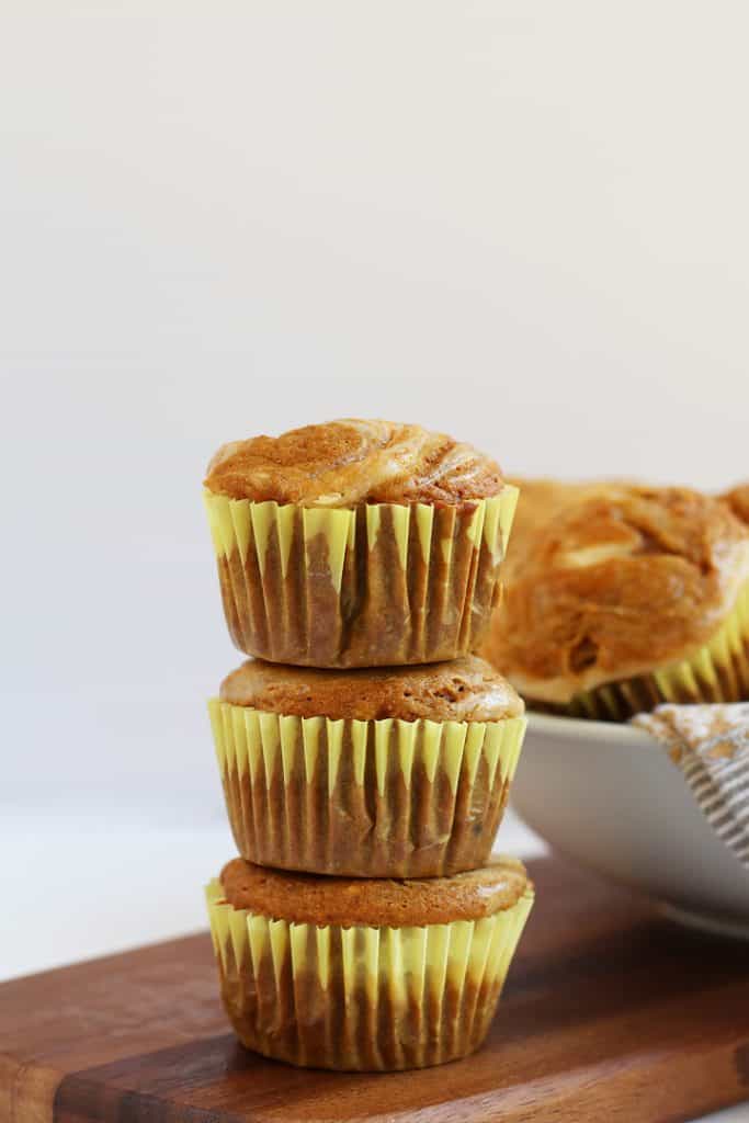 Stack of three Pumpkin Cream Cheese Muffins