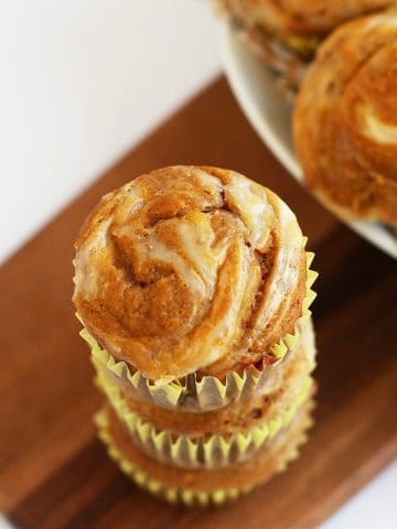 Stack of finished muffins on a wooden platter