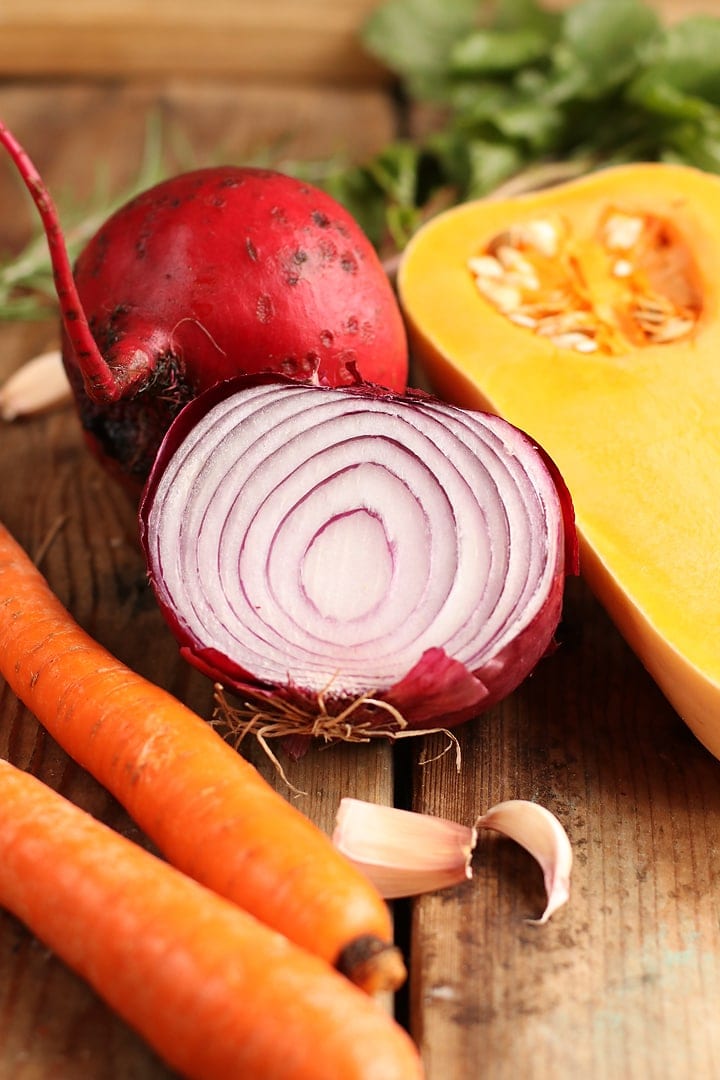 Squash, onion, beets, and carrots on wooden background