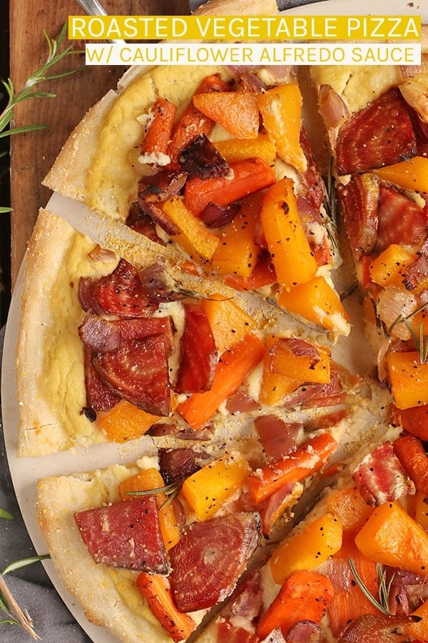 A roasted vegetable pizza made with roasted butternut squash, beets, carrots served a top vegan cauliflower Alfredo Sauce on a cornmeal pizza crust. #vegan #vegetarian #caulifloweralfredo #pizza #veganpizza #fallrecipes #roastedvegetables #homemadepizza #recipes #mydarlingvegan