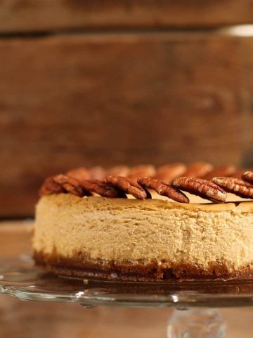 Vegan Pumpkin Cheesecake on a glass cake stand