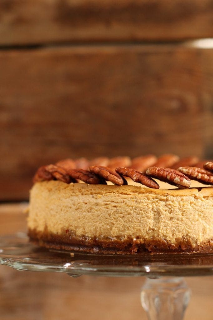 Vegan Pumpkin Cheesecake on a glass cake stand