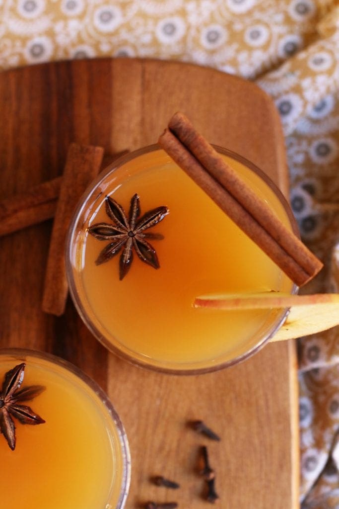 Orange Spiced Bourbon in a cocktail glass with a cinnamon stick