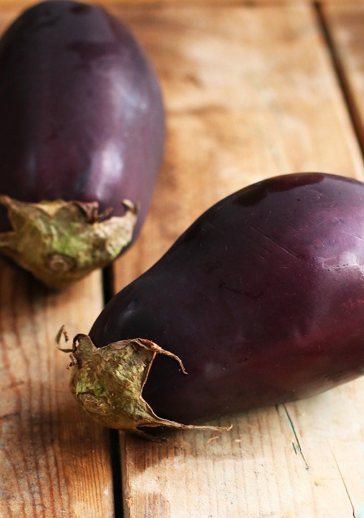Two eggplants on a wooden background