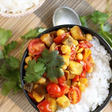 Finished dish served over rice in a small black bowl