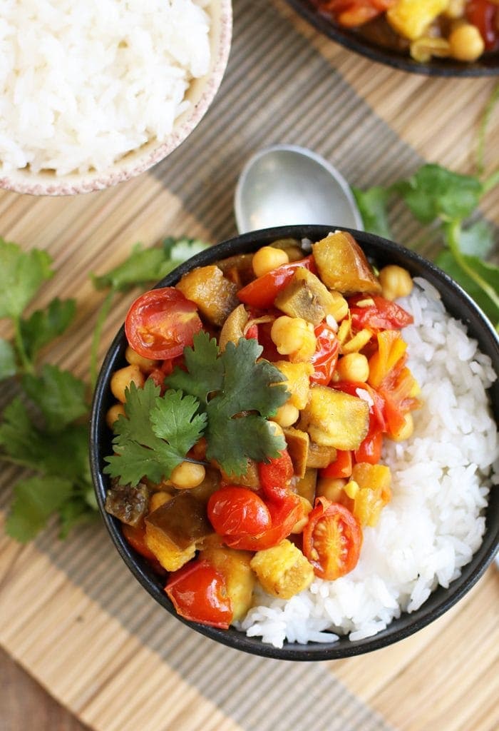 Finished dish served over rice in a small black bowl