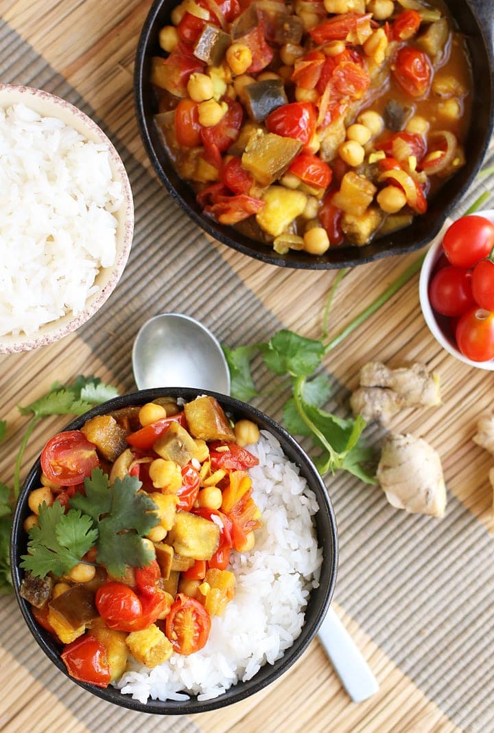 Two bowls of eggplant curry served with rice