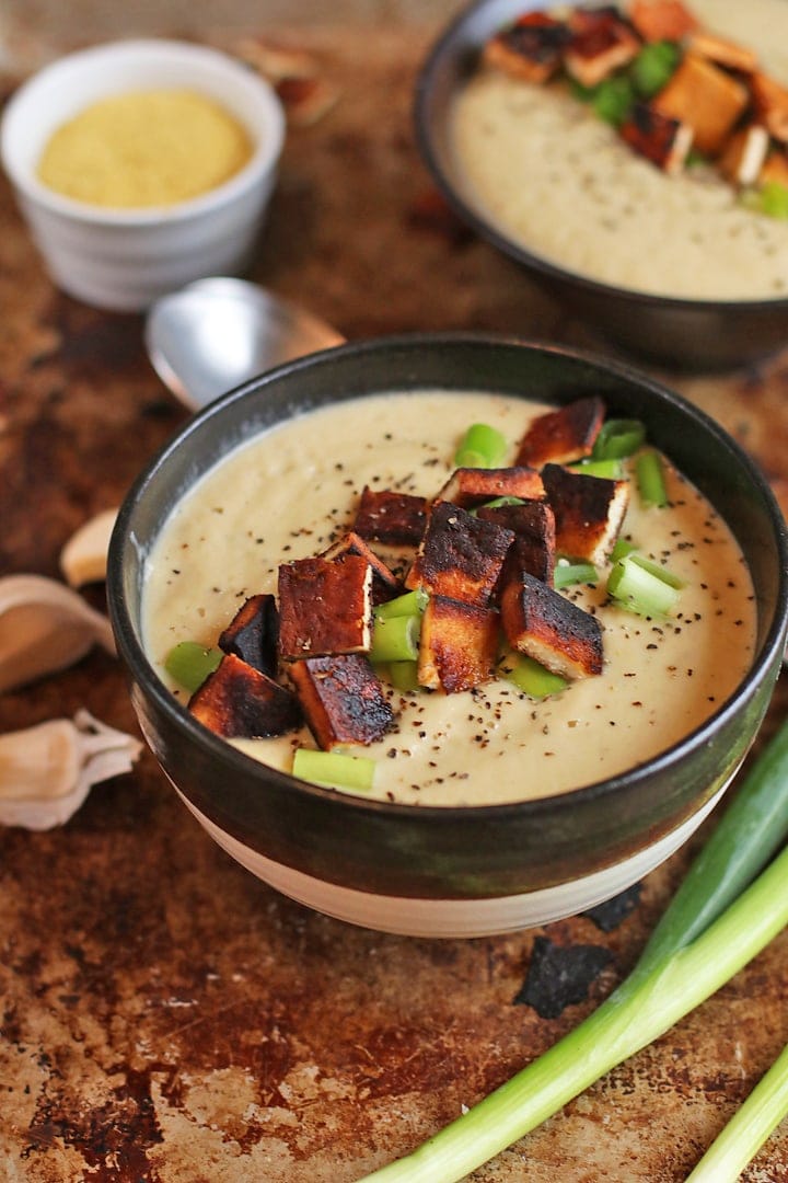 Finished soup in a black and white bowl 