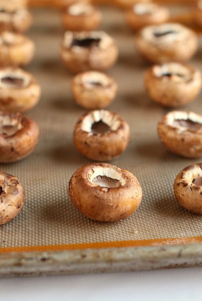 Hollowed portobello mushrooms on a baking sheet