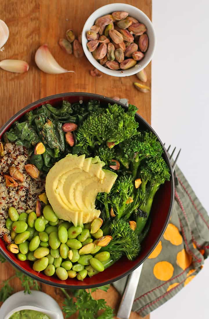 Broccoli, edamame, quinoa, and avocado in a small black bowl