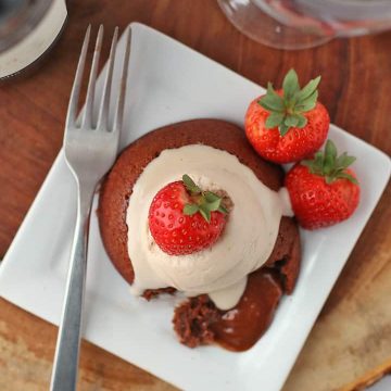 Piece of Chocolate Lava Cake on a white plate with a fork