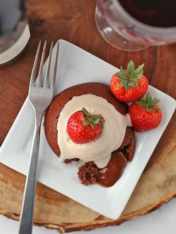 Piece of Chocolate Lava Cake on a white plate with a fork