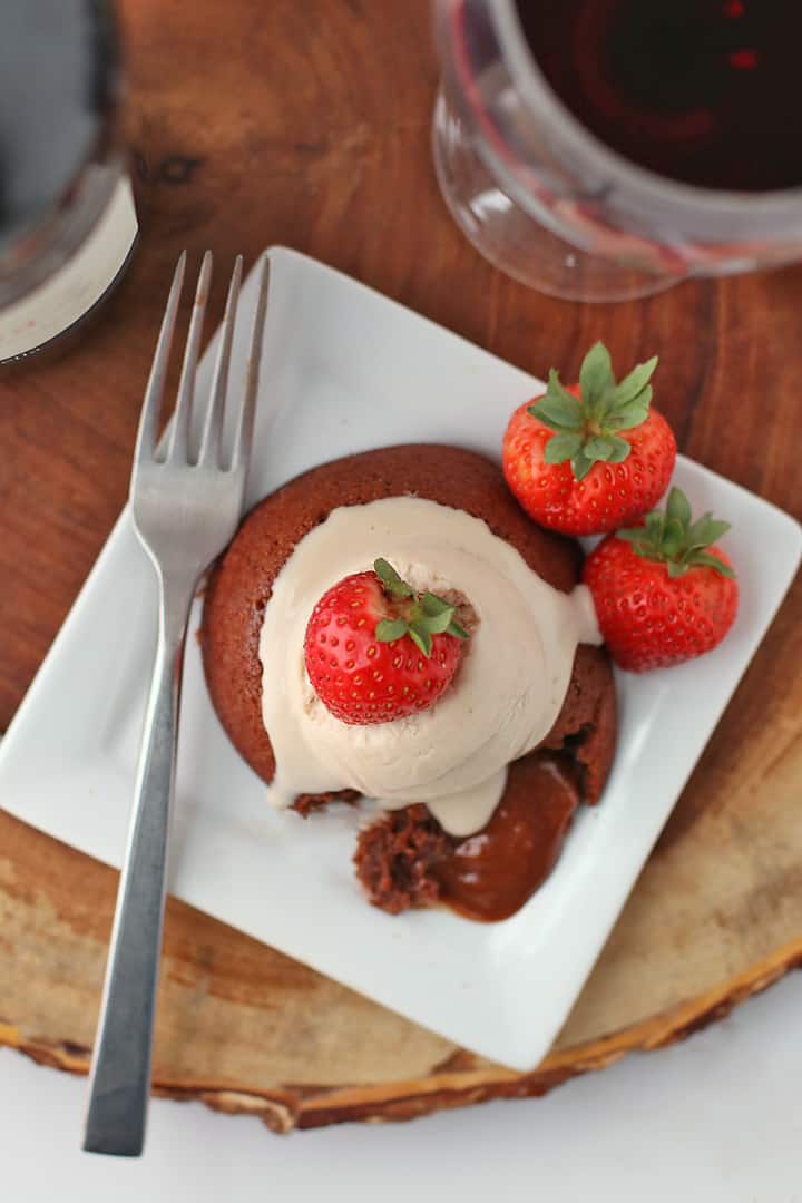 Piece of Chocolate Lava Cake on a white plate with a fork