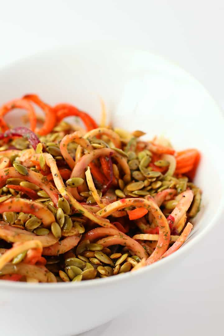 Spiralized Vegetables and pumpkin seeds in a large white bowl