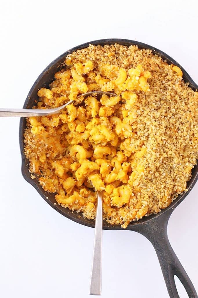 Finished pasta in a cast iron skillet with two forks