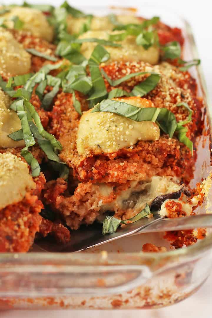 Vegan Eggplant Parmesan in a glass casserole dish