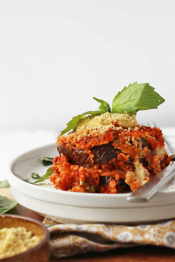 Piece of eggplant parmesan on a white plate