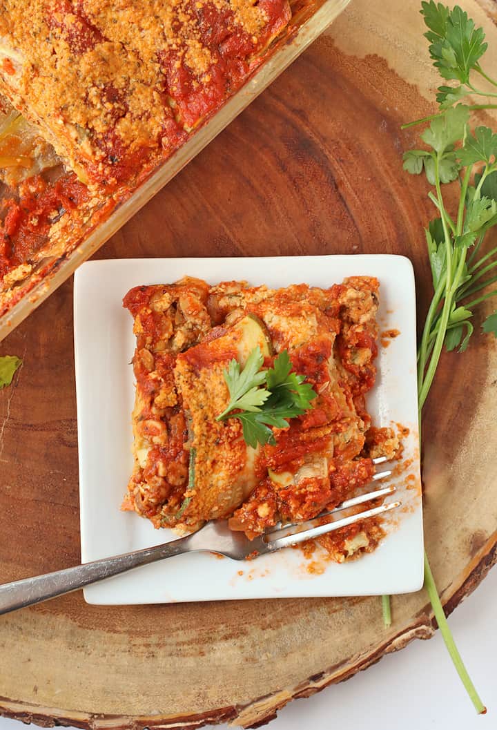 Vegan Zucchini Lasagna on a white plate with a fork