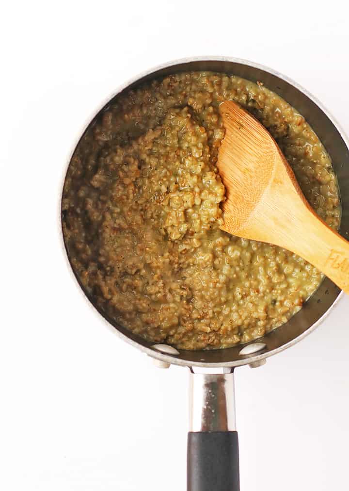 Matcha Oatmeal in a saucepot with a wooden spoon