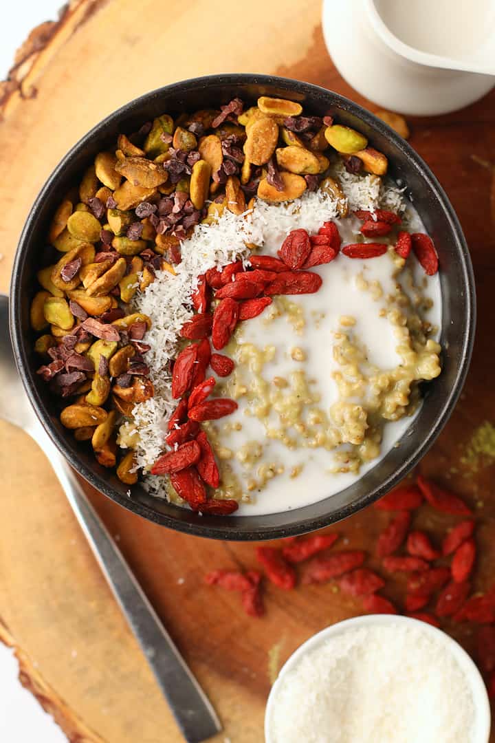 Finished oatmeal topped with nuts, berries, and milk