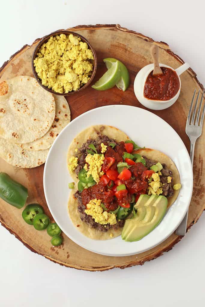 Vegan rancheros with salsa, avocado, and lime.