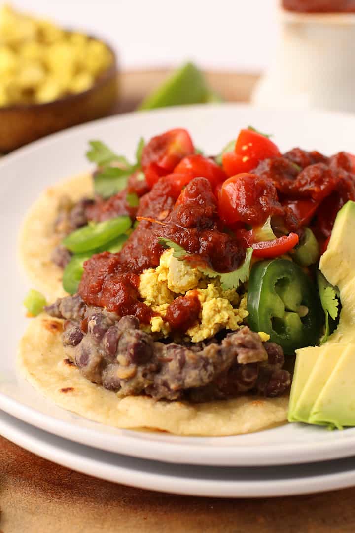 Refried beans and scrambled tofu on crispy tortillas