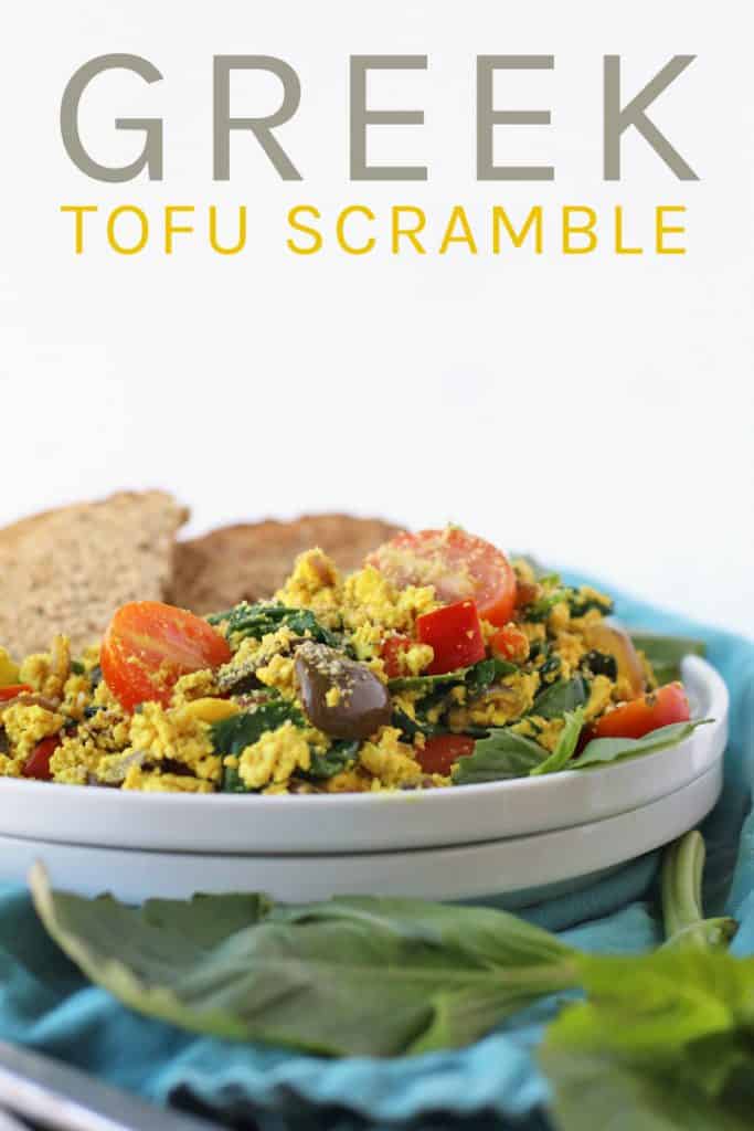 Start your day off right with this hearty and wholesome vegan Greek Tofu Scramble. It is made with seasoned tofu, olives, spinach, and fresh tomatoes for a delicious plant based and gluten free meal.