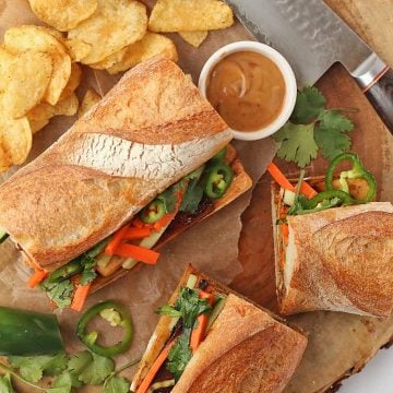 Tofu Banh mi sandwich on a platter with chips