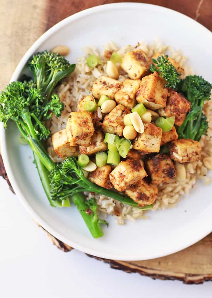 Finished recipe with broccolini and rice on a white plate.