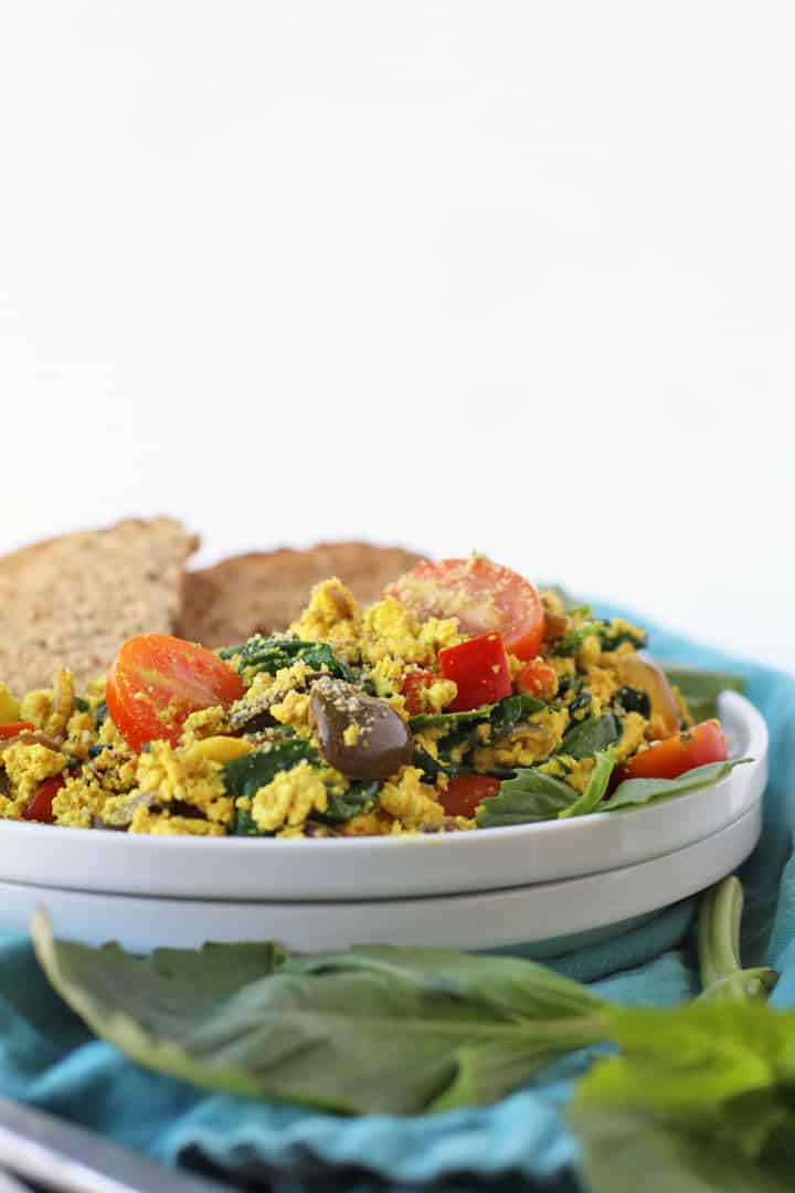 Tofu scramble on a white plate with toast