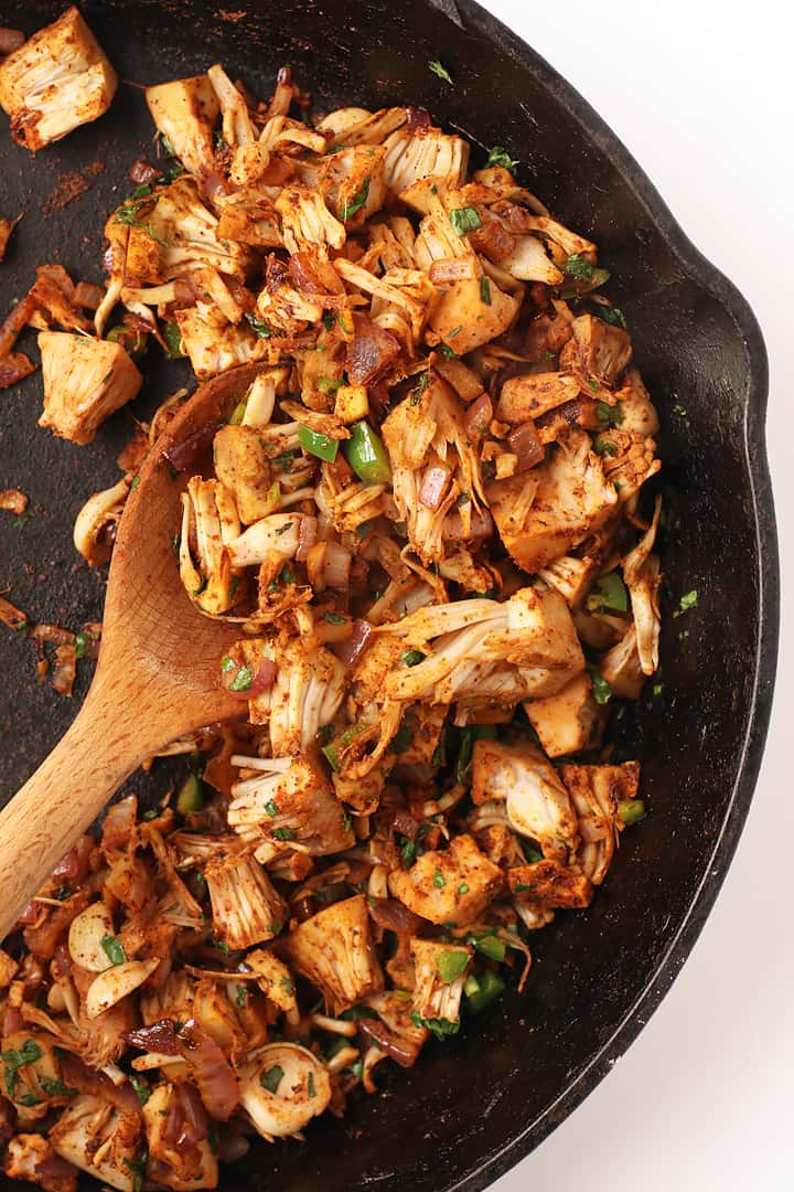 Sautéed jackfruit and peppers in a cast iron skillet