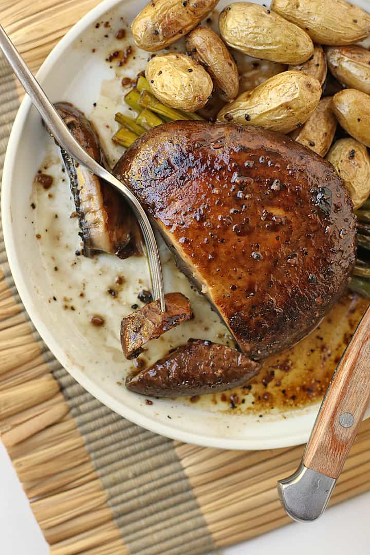 Portobello Steak on a white plate with a fork