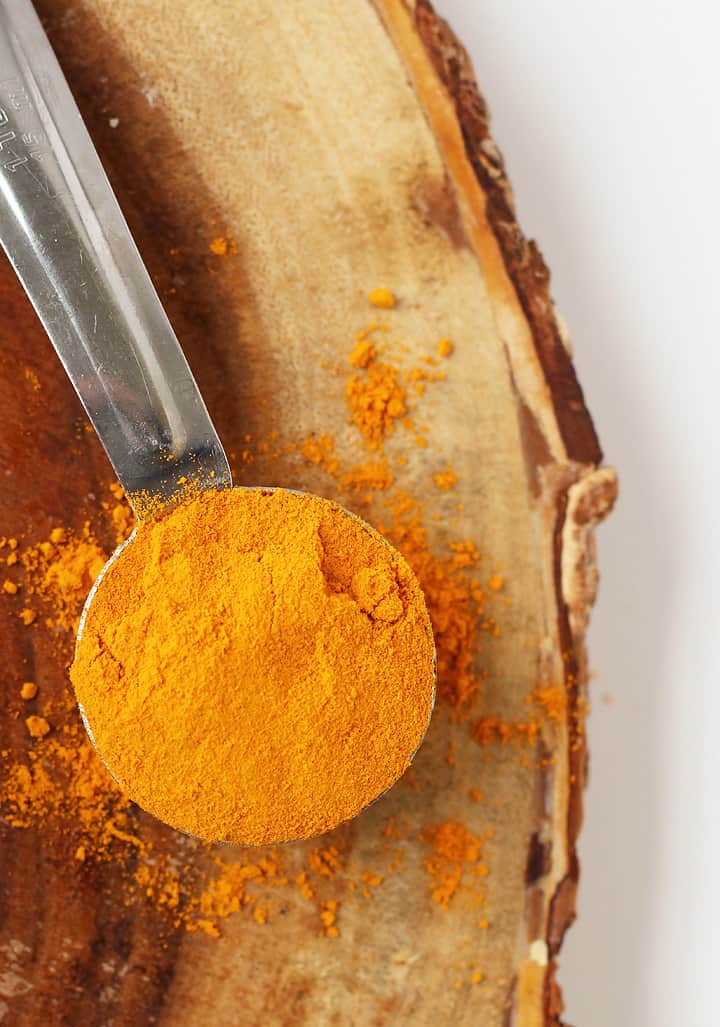 Powdered turmeric in a tablespoon