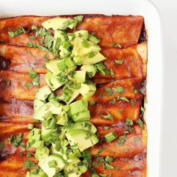 Vegan Enchiladas in a white casserole dish