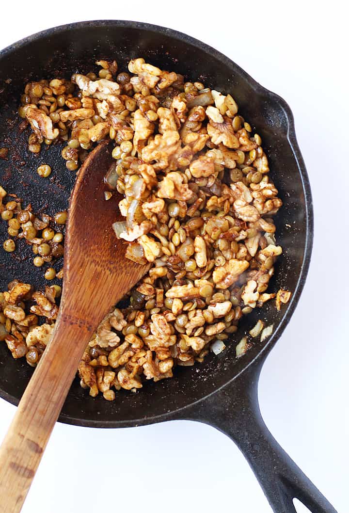 Sautéed onions and walnuts in a skillet