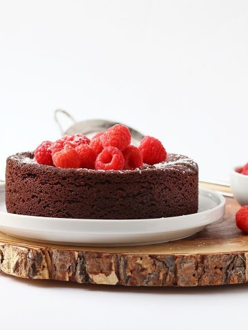 Finished cake topped with fresh raspberries