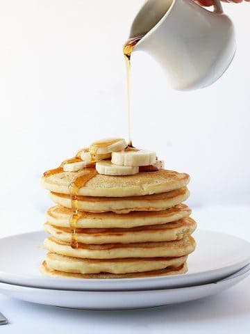 Finished recipe stacked on a white plate with maple syrup